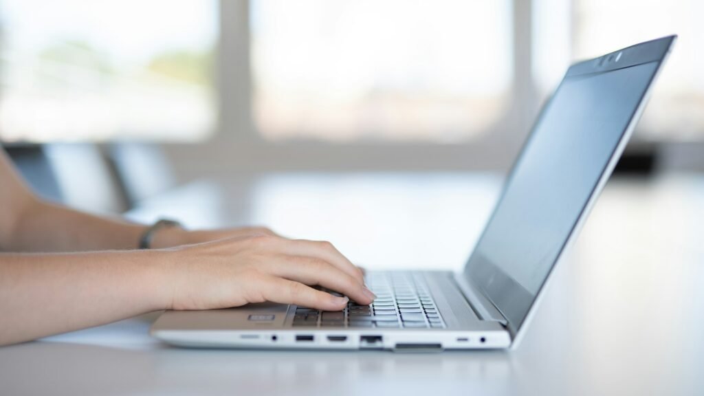 Contact form design: close-up of a person typing on a laptop