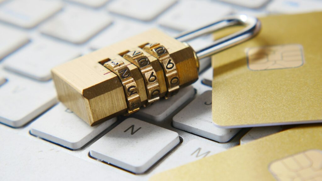 A golden padlock sitting on top of a keyboard