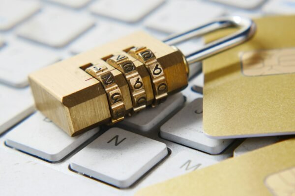 A golden padlock sitting on top of a keyboard