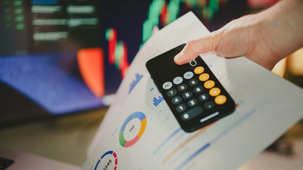 Xero and QuickBooks integration concept: a person holding a calculator over paperwork