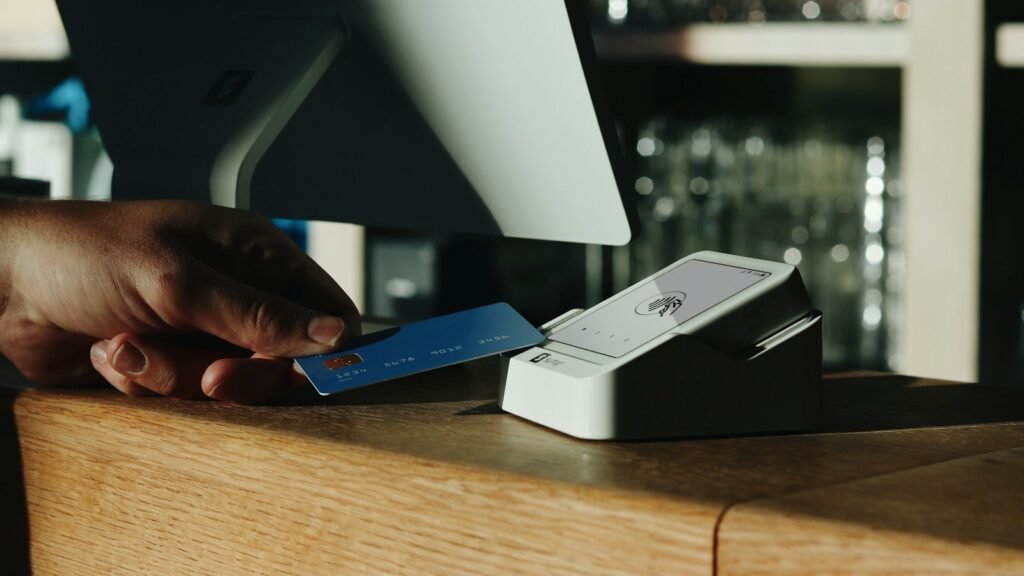 Taking deposits online: a person holding a credit card in front of a computer