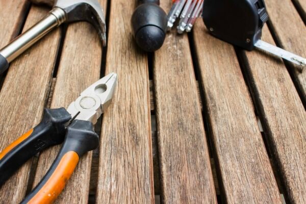 Assorted-type carpentry tools on brown surface