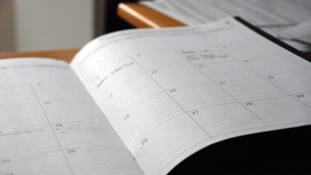 Open monthly planner on wooden desk