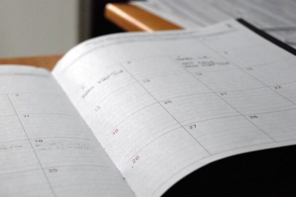 Open monthly planner on wooden desk