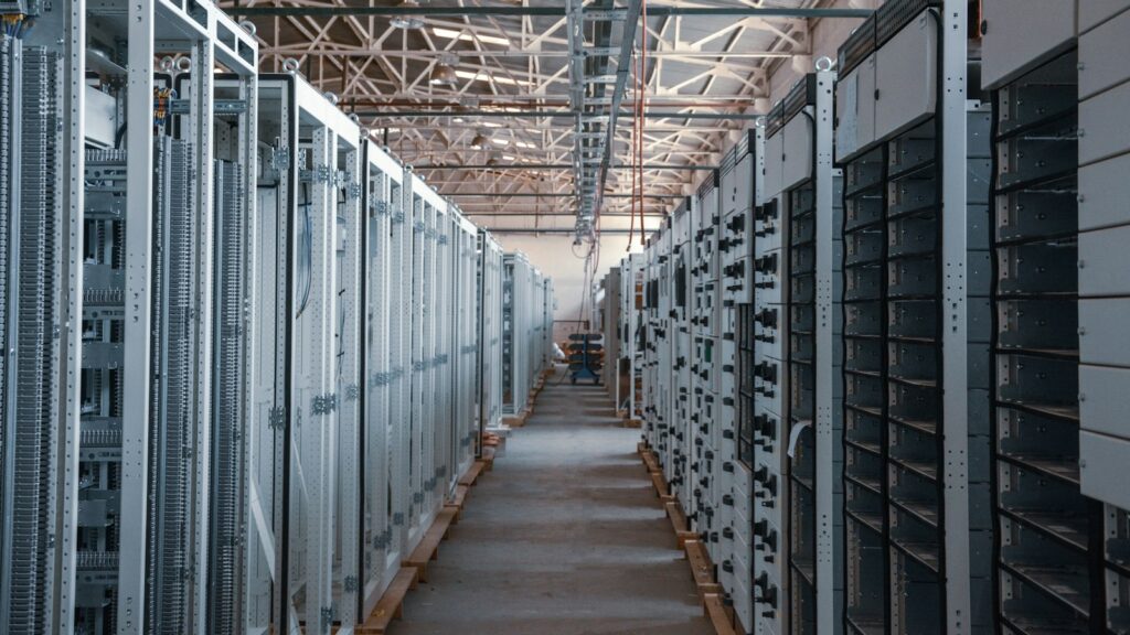 Server room aisle with metal equipment racks