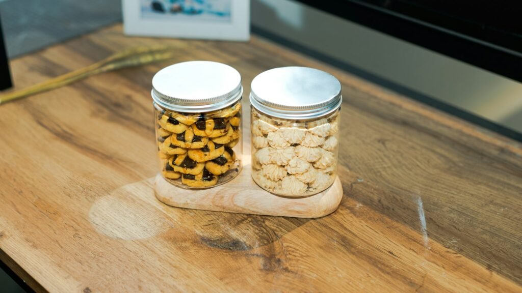 Cookie consent concept: two jars of cookies on a wooden stand