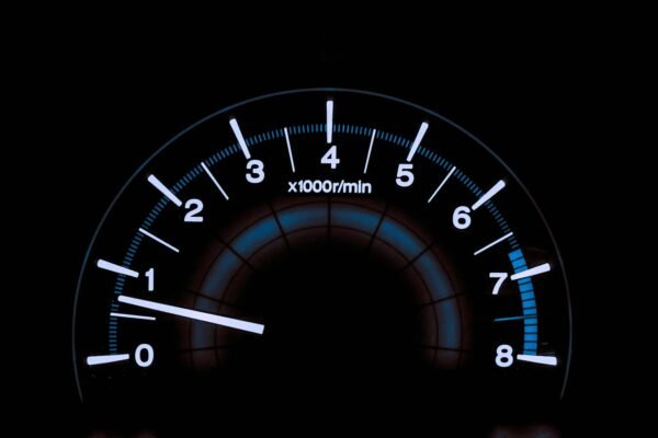 White and blue analog tachometer gauge