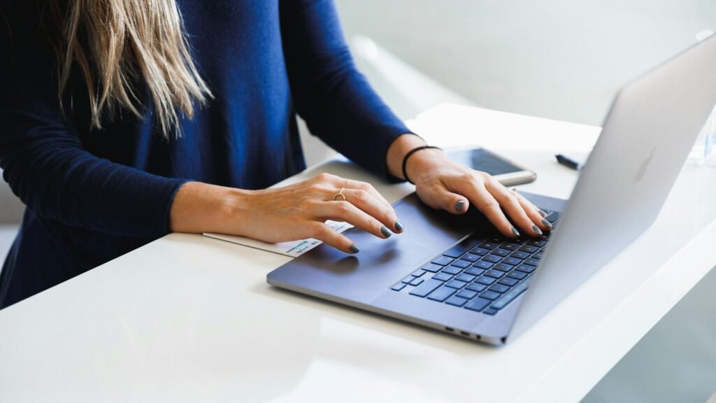 Writing service pages: woman in a blue shirt using a MacBook Pro