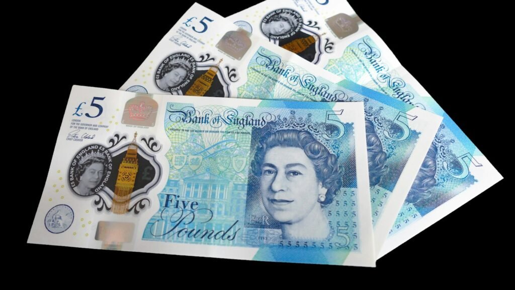 A pile of five different british pound notes