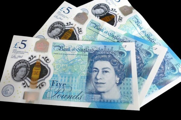 A pile of five different british pound notes