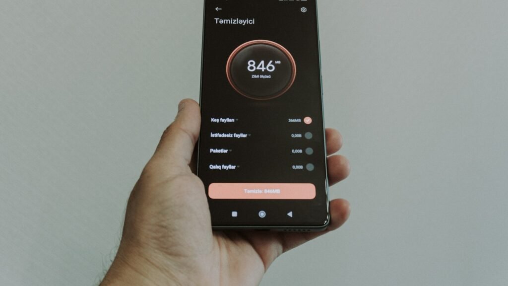 Hand holding smartphone displaying a health application
