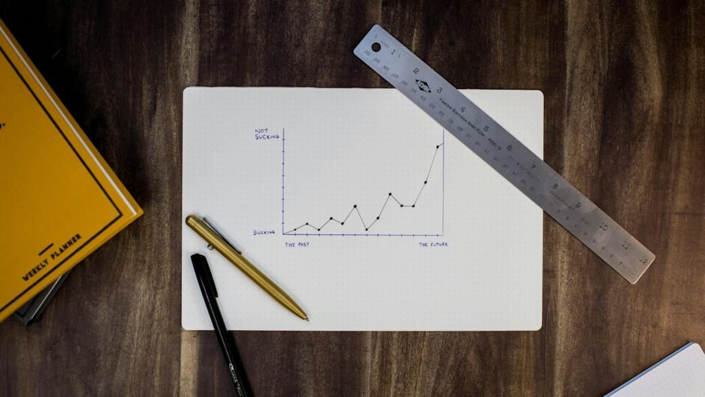 Website ROI growth shown as a hand-drawn line graph with a ruler and pens