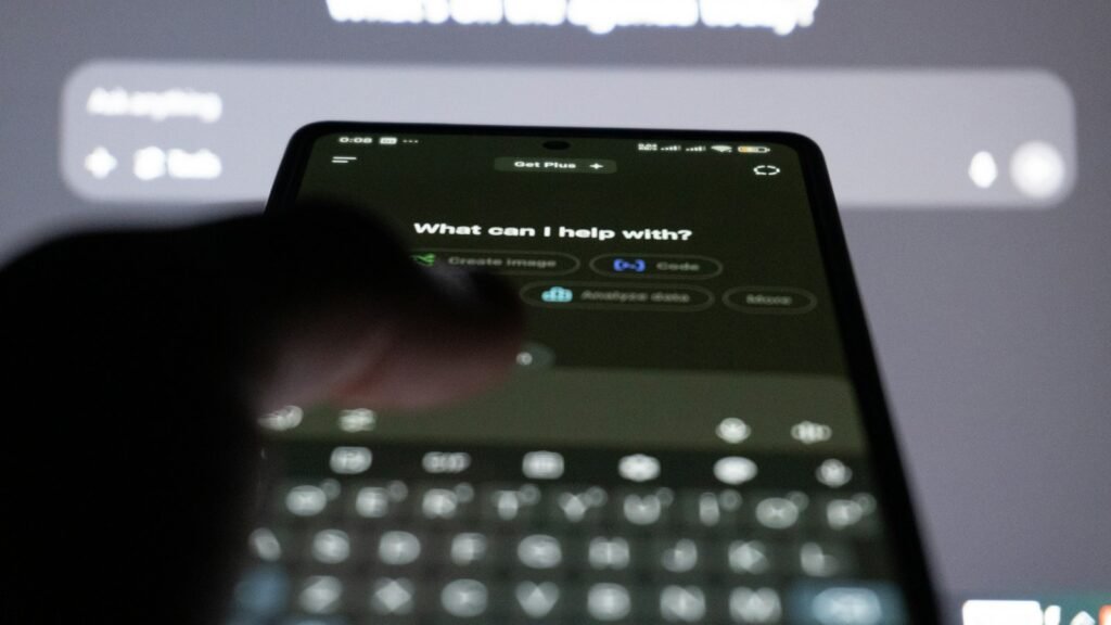 Person typing on smartphone with ai chatbot on screen