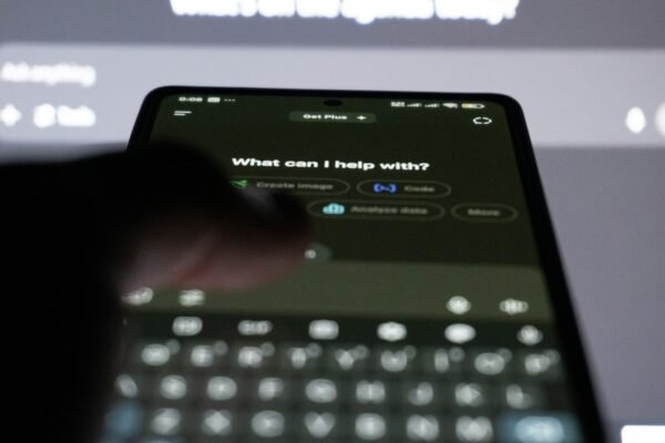 Person typing on smartphone with ai chatbot on screen