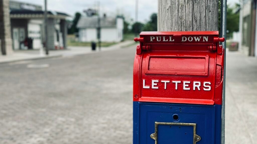Email deliverability concept: a red mail box on a wooden post