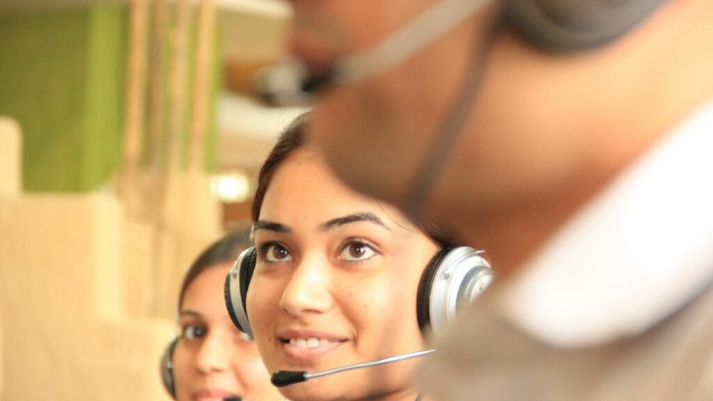 AI chatbots supporting customer service staff wearing headsets in a bright office