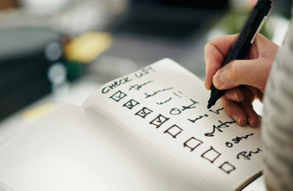 Pen ticking items off a printed checklist, the way to approach a legacy system modernisation