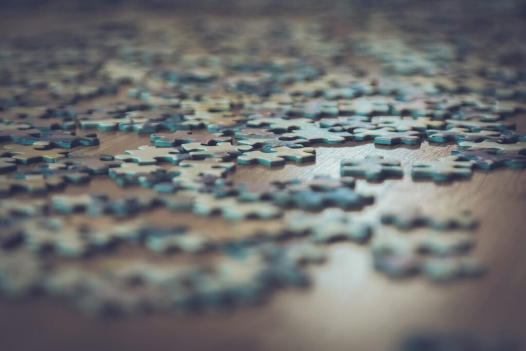 Jigsaw puzzle pieces scattered on a wooden table, a simple picture of API integrations
