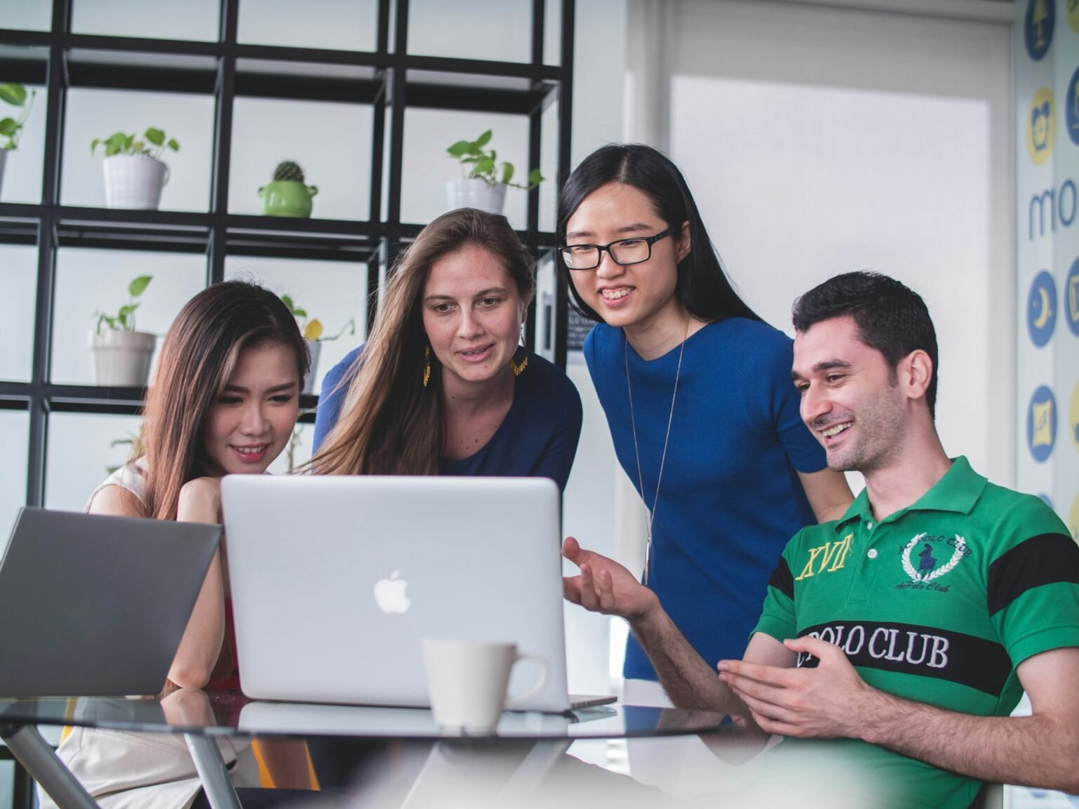 The Extra Web Solutions team reviewing a website together on a laptop
